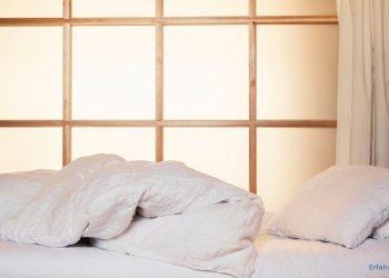 Zudecke und Kopfkissen auf einem Bett