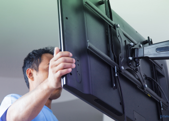 Mann richtet einen TV aus