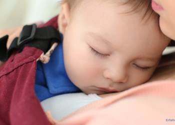 Baby schläft in einer Babytrage